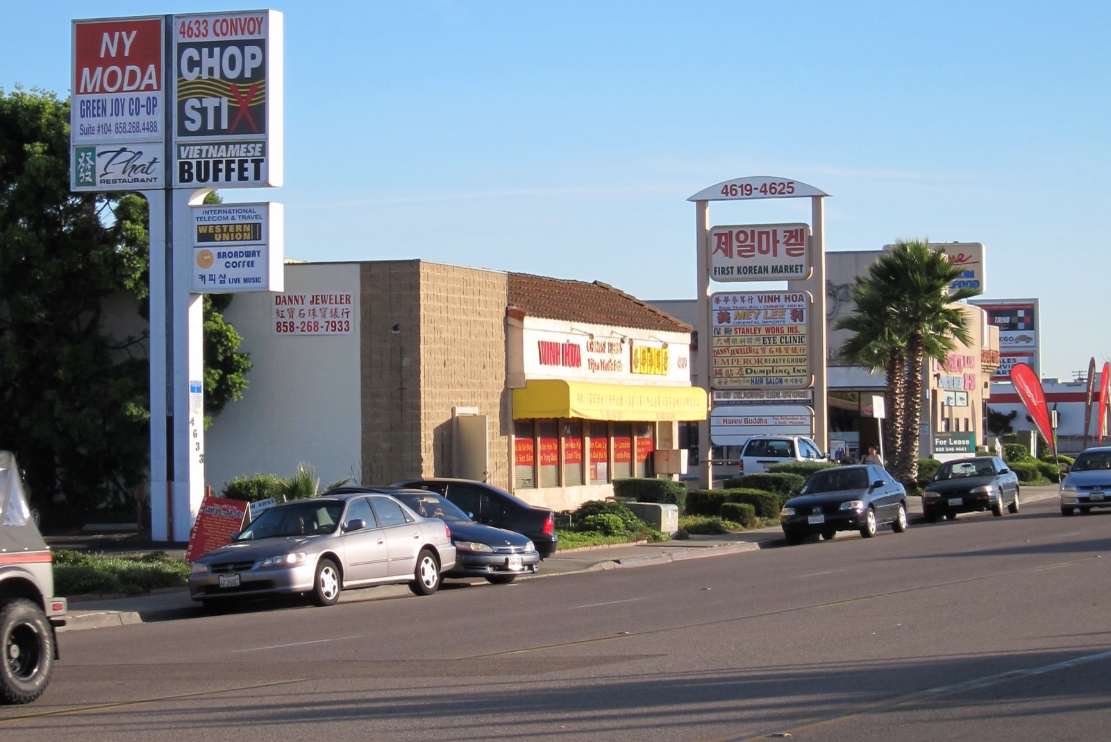 Convoy Street businesses in Kearny Mesa San Diego with Vietnamese and Korean signage and parked cars