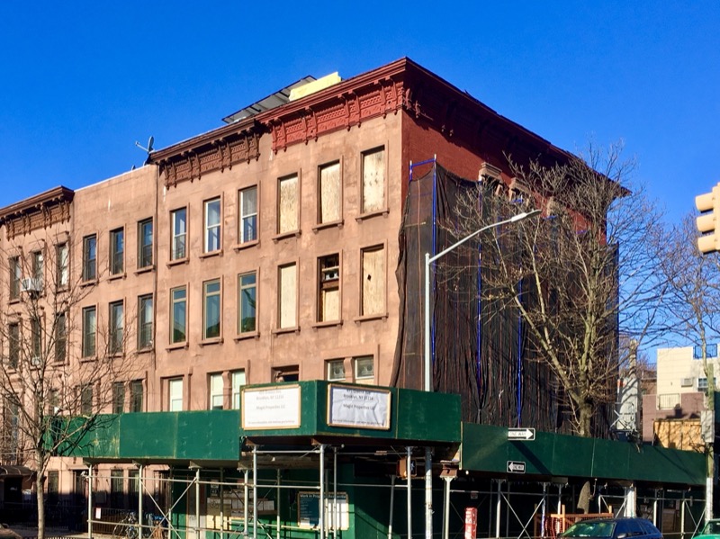 Brooklyn street corner at Nostrand Avenue and Greene Avenue in Bedford-Stuyvesant with subway entrance and corner store