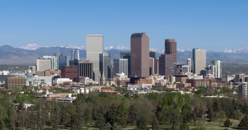 Downtown Denver skyline with the Colorado State Capitol gold dome and the Rocky Mountains in the distance