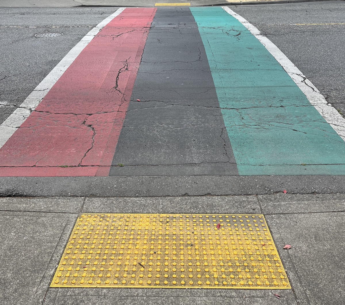 East Union Street pedestrian crossing painted in the Pan-African flag colors in Seattle's Central District near Ponder Super Chronic Club