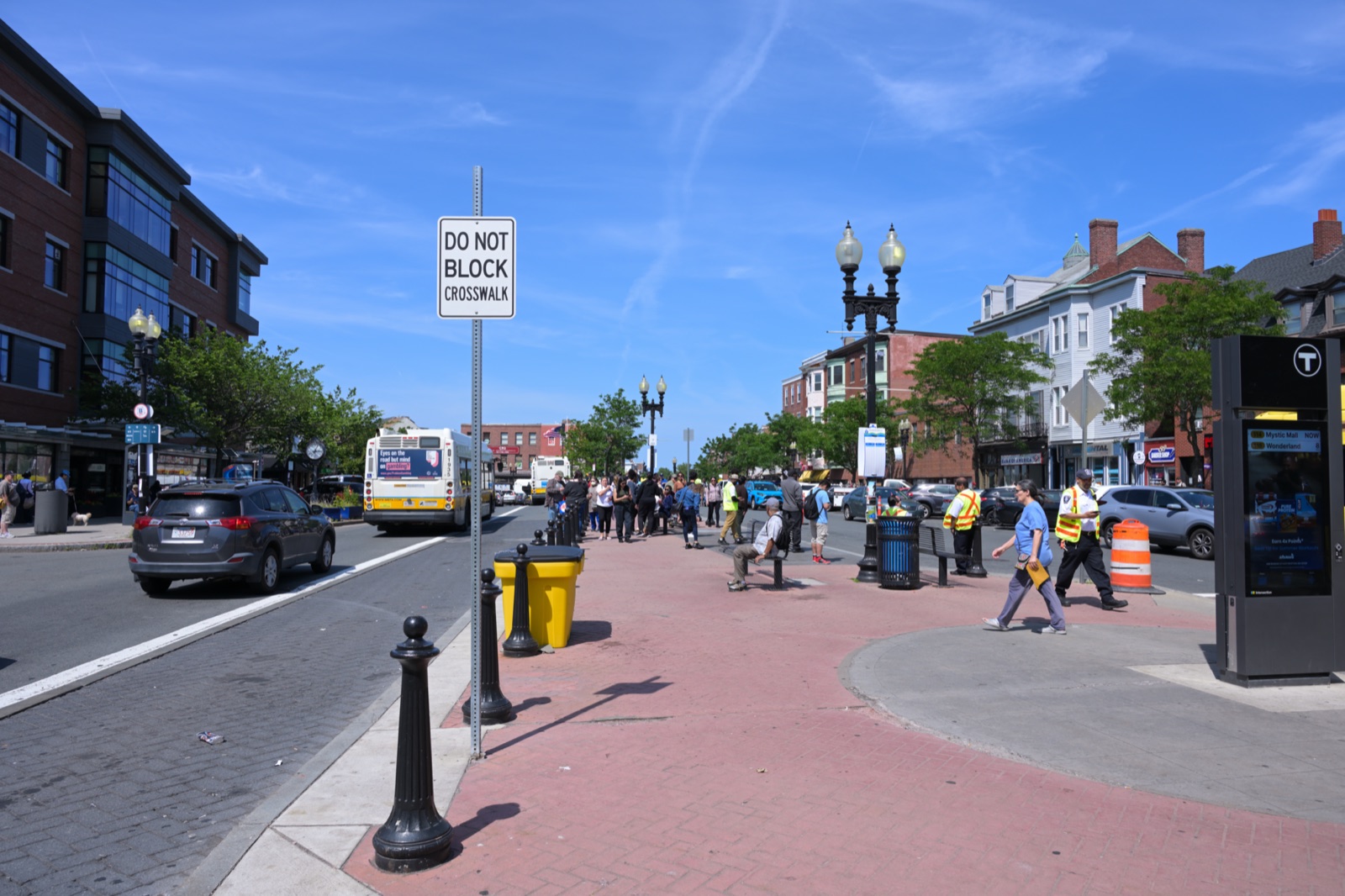 Maverick Square in East Boston with the MBTA Blue Line station T sign and Bennington Street commercial buildings on a clear summer day near Berkshire Roots dispensary