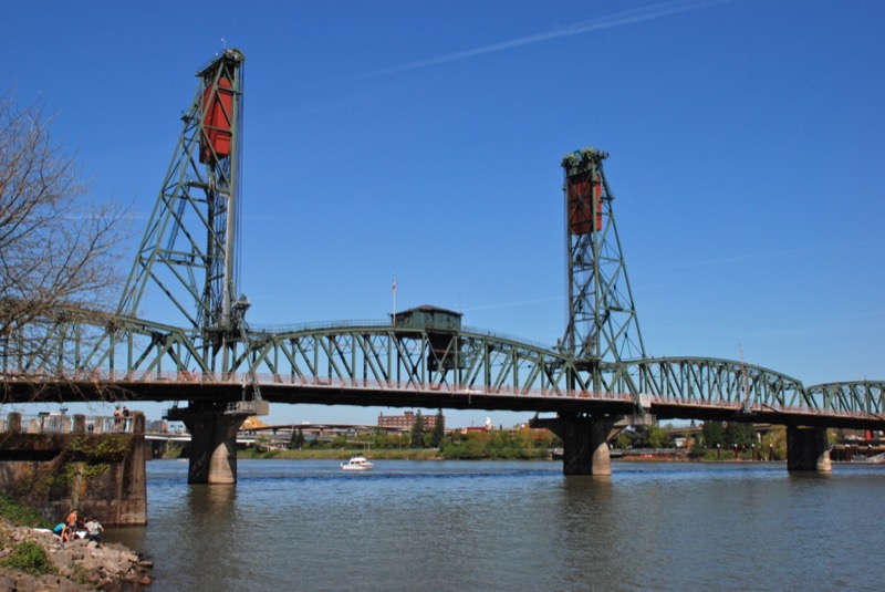 Hawthorne Bridge over the Willamette River with downtown Portland skyline behind it
