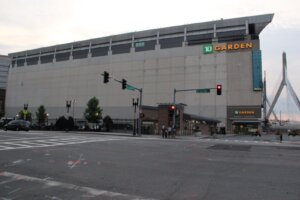TD Garden arena exterior at North Station with the Leonard Zakim Bunker Hill Bridge cable-stay tower visible at right in Boston West End
