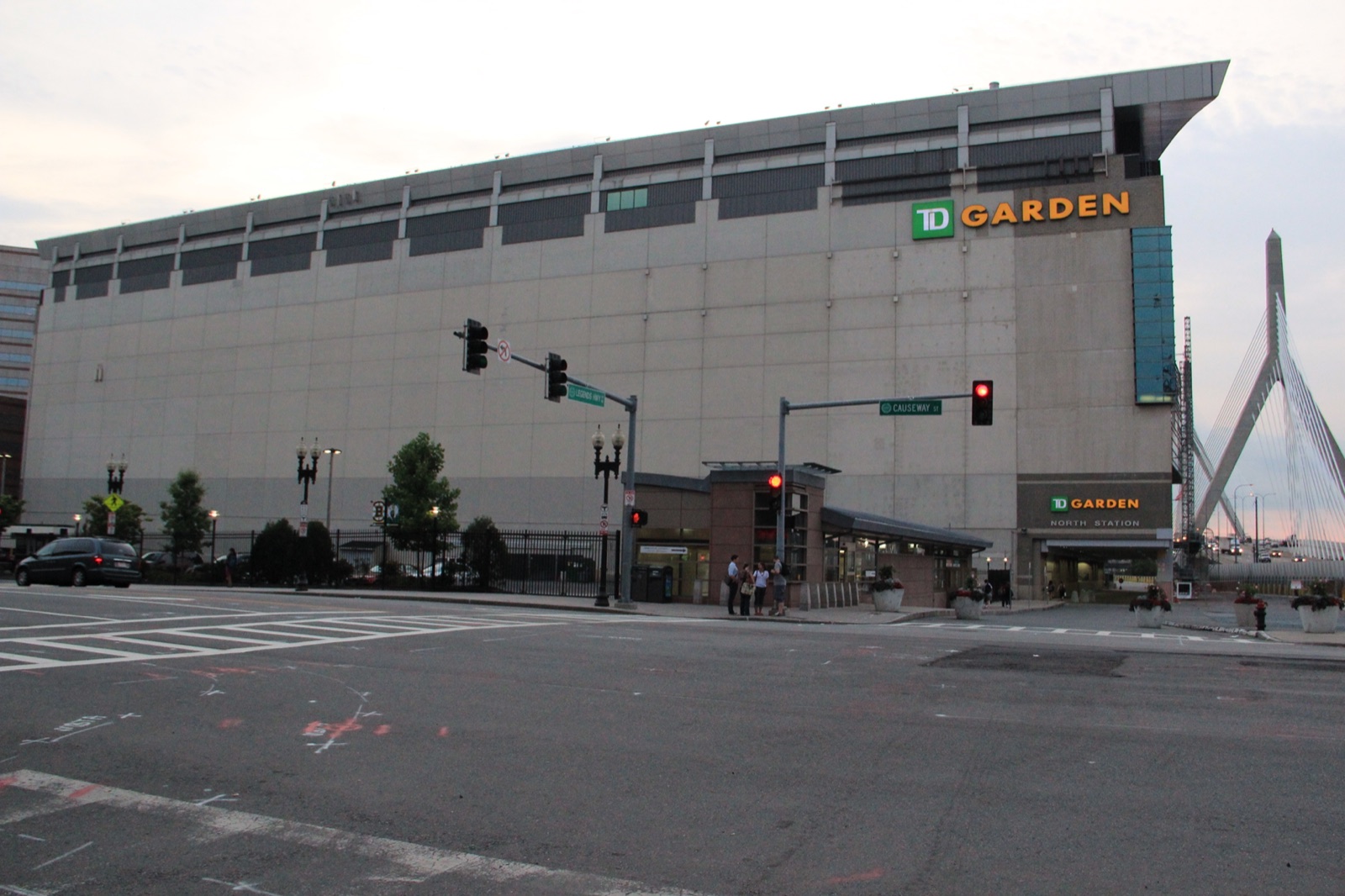 TD Garden arena exterior at North Station with the Leonard Zakim Bunker Hill Bridge cable-stay tower visible at right in Boston West End near Ascend dispensary