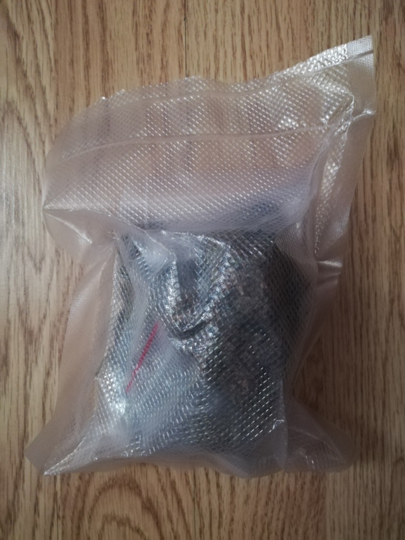An ounce (zip) of dried cannabis flower in a sealed retail bag, the standard adult-use single-purchase limit