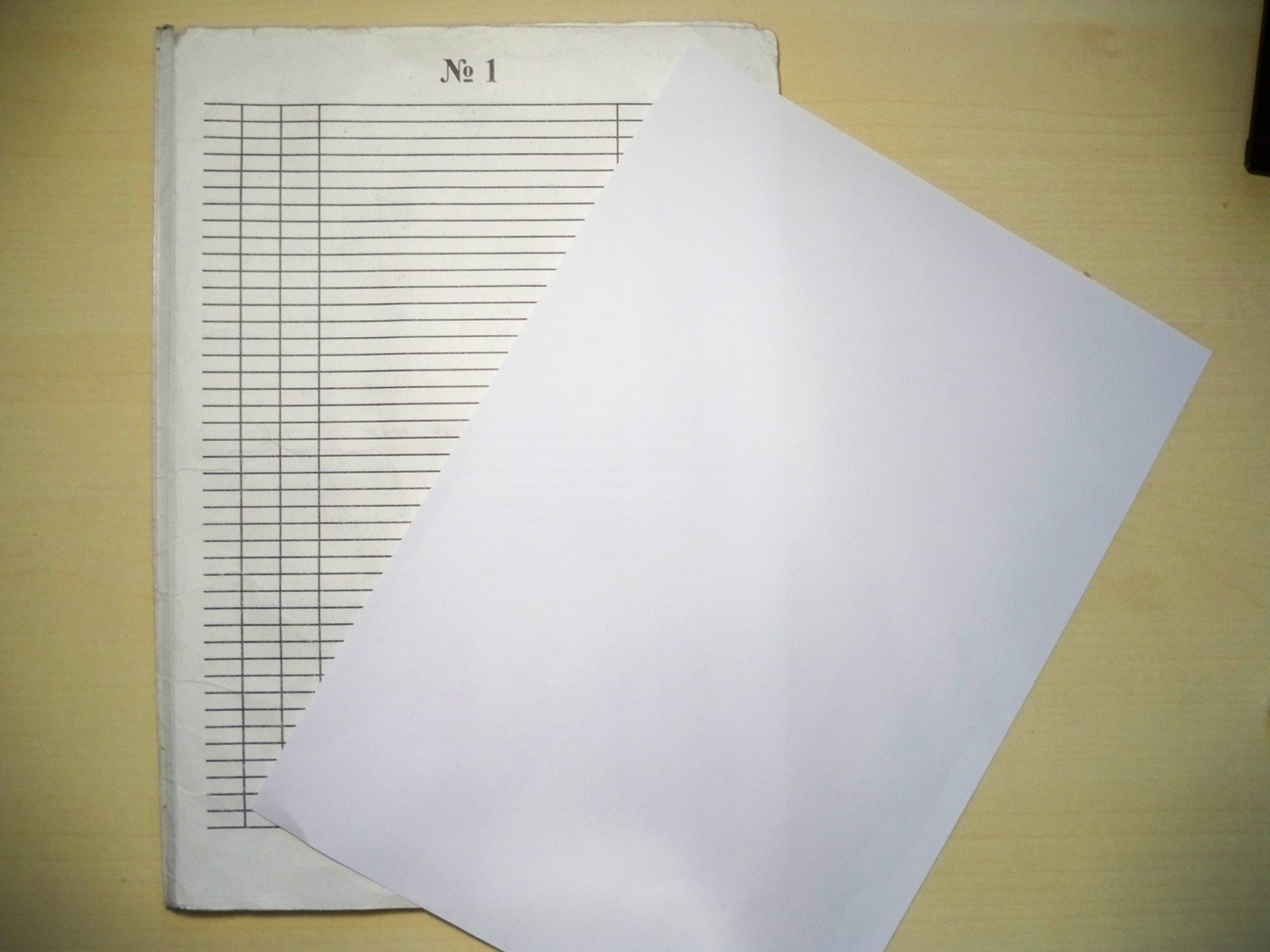 Sheet of ruled notebook paper with blue horizontal lines, a common household paper people ask about rolling weed with