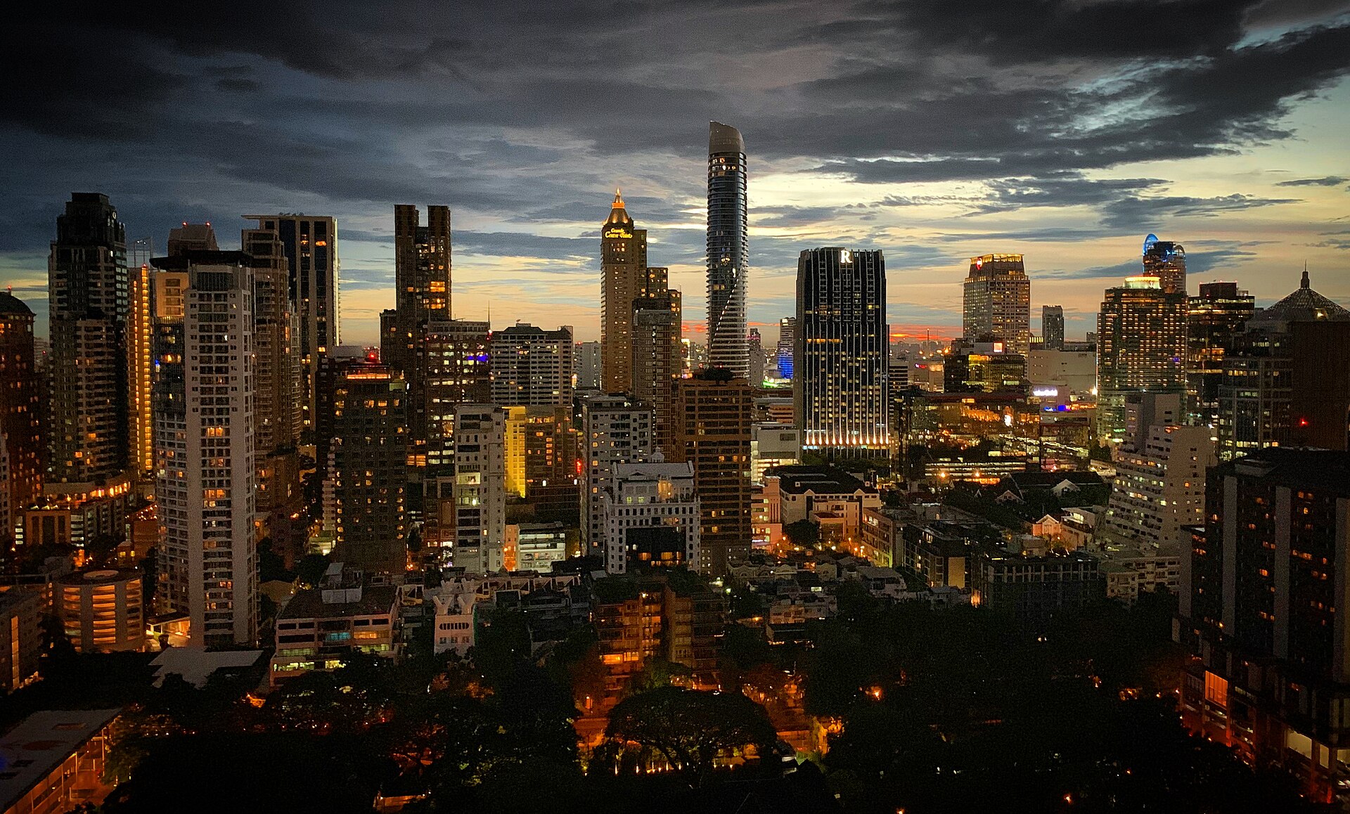 The Bangkok skyline at twilight, with lit high-rise towers in the Ratchadamri district
